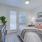 a bedroom with a bed and a mirror